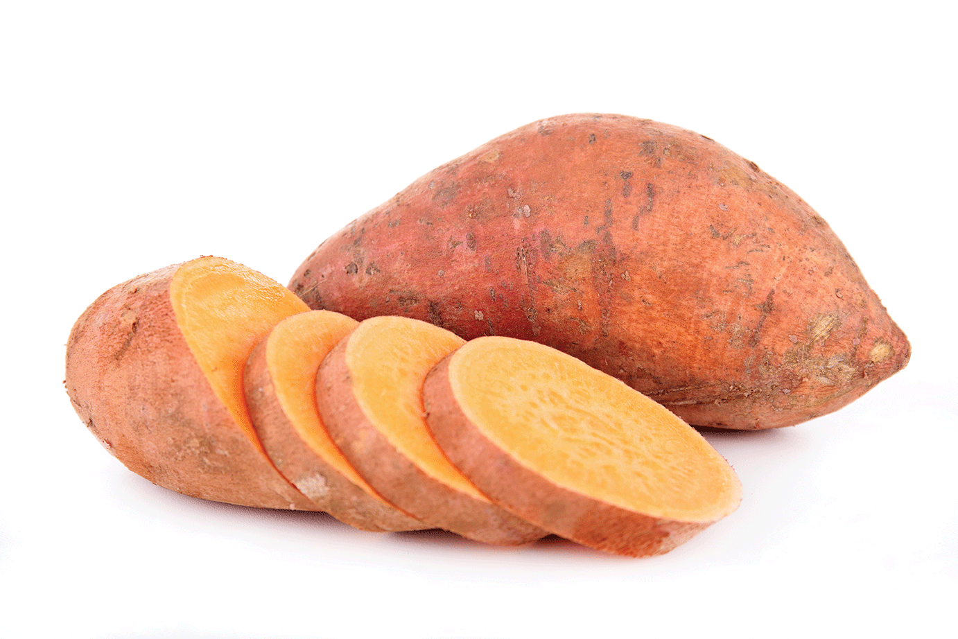 Sweet potatoe slices in front of whole sweet potatoe.